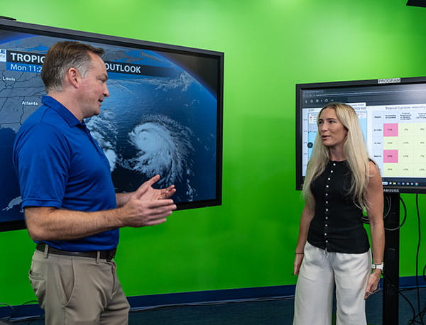 Professor Rob Eicher with a student in the Meteorology Broadcasting Studio