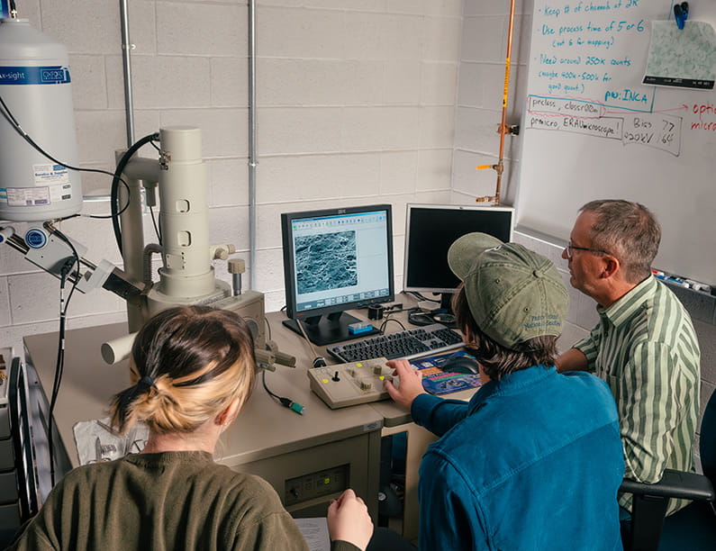 Students with a professor in the Microscopy Lab