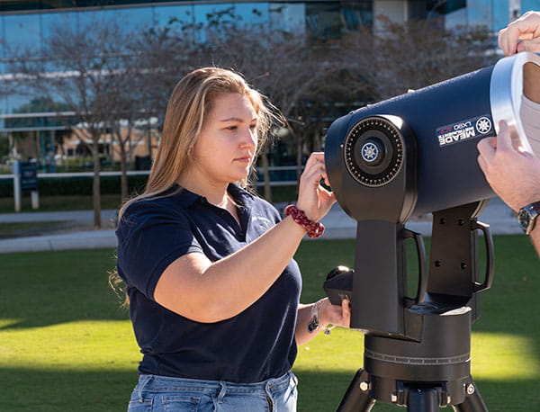 An Embry-Riddle student uses a telescope.