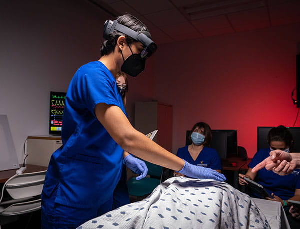A student practices on a medical dummy in the Embry-Riddle REACH Lab.