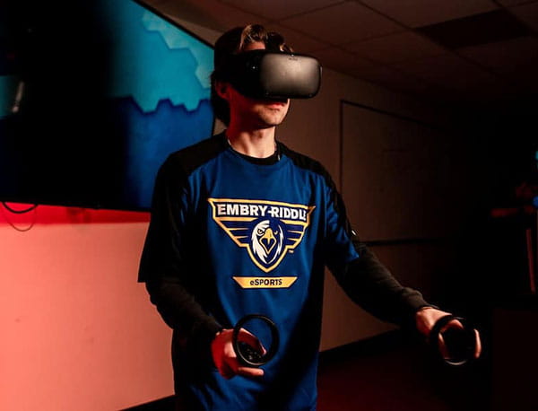 An Embry-Riddle student wears and uses VR headset technology.