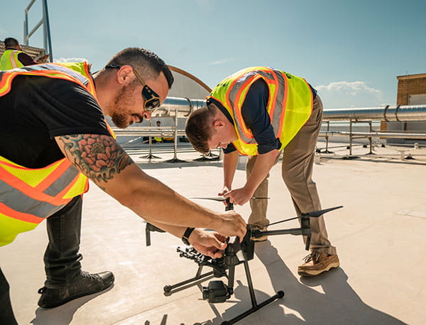 UAS students setting up a drone for flight.