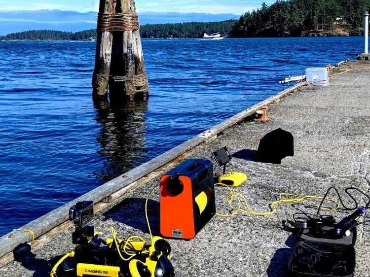 Equipment from the Uncrewed Pilot Trainer sits on a dock by the water