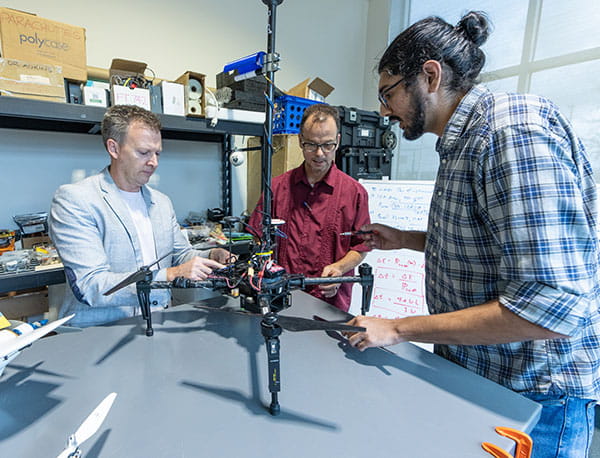 Dr. Kevin Adkins, Dr. Marc Compere and Dr. Avinash Muthu Krishnan work in the Uncrewed Vehicle and Atmospheric Investigation Lab