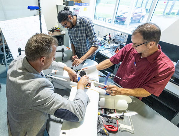 Dr. Kevin Adkins, Dr. Marc Compere and Dr. Avinash Muthu Krishnan work in the Uncrewed Vehicle and Atmospheric Investigation Lab