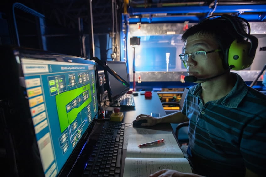 Student at computer in wind tunnel