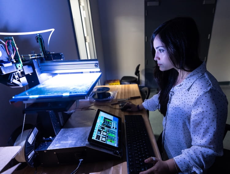 Student sitting at a desk in a lab
