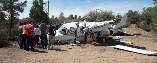 Embry-Riddle Prescott students examine a plane crash