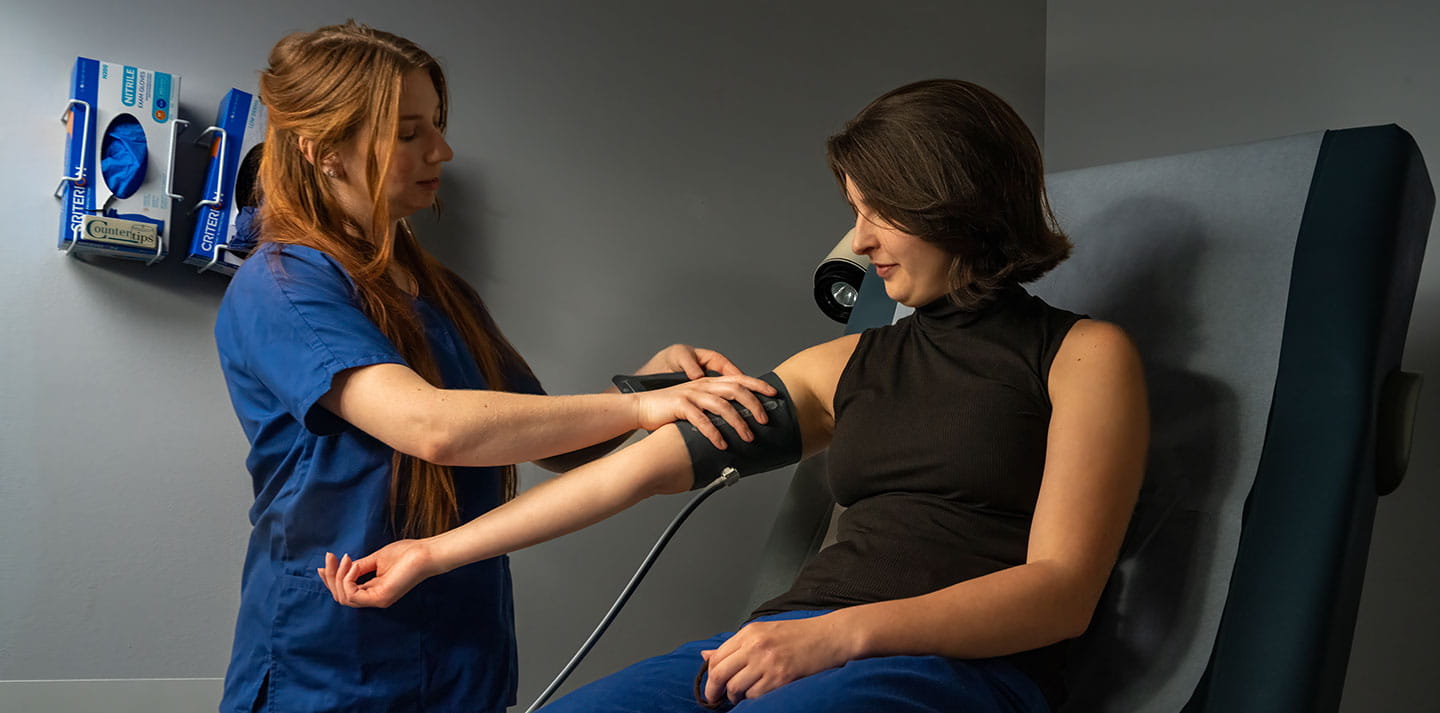 A nurse takes a patient's blood pressure