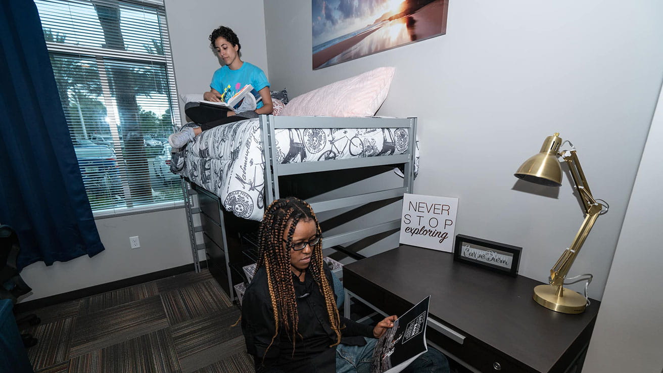 Two students relaxing in their dorm room