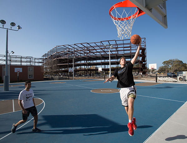 Embry-Riddle students play basketball at the Daytona Beach basketball courts