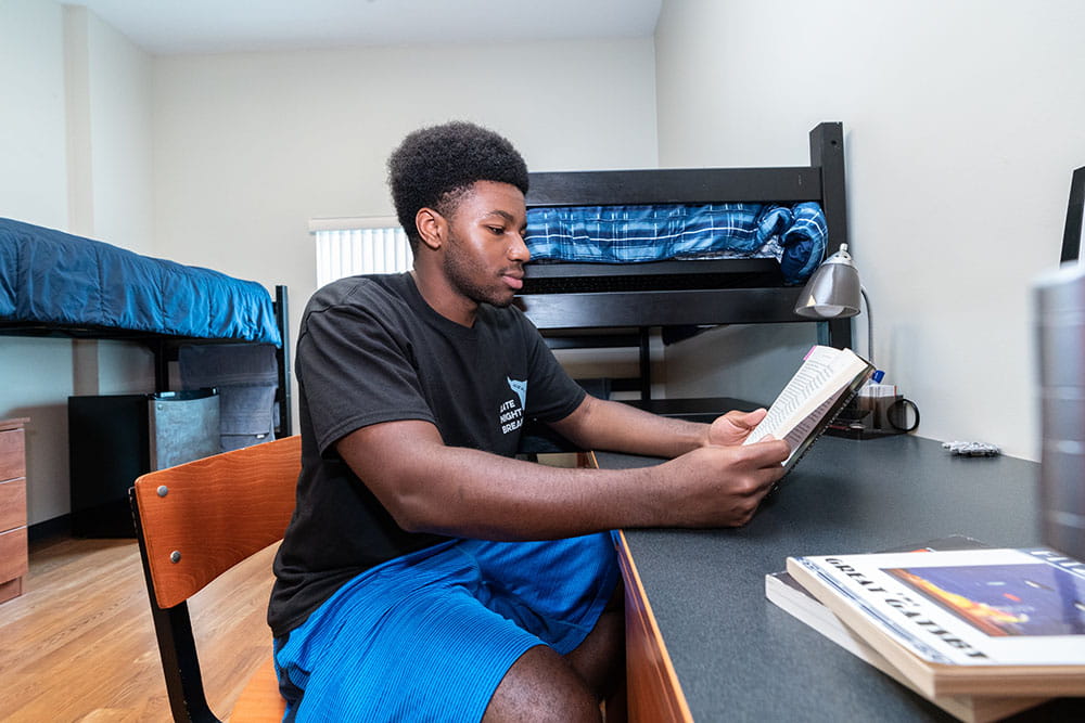 Embry-Riddle student sits at a desk in Apollo Hall
