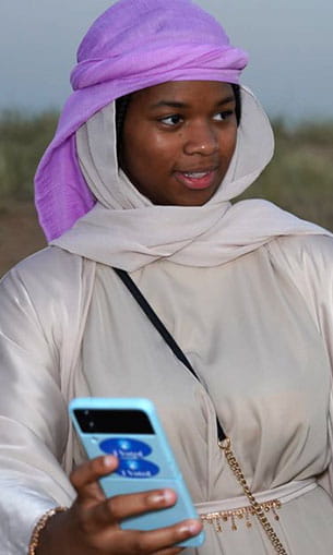 A student wearing a purple headdress
