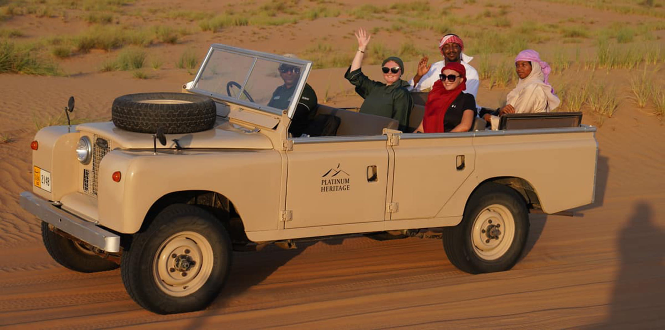 Students riding in a car in the desert