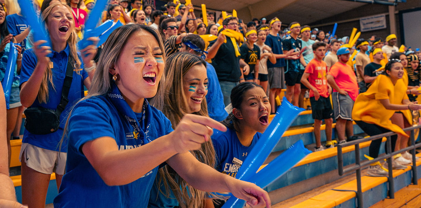Embry-Riddle students showing school spirit cheering in the stands at a game
