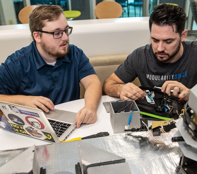 Two students work together on a robotics project