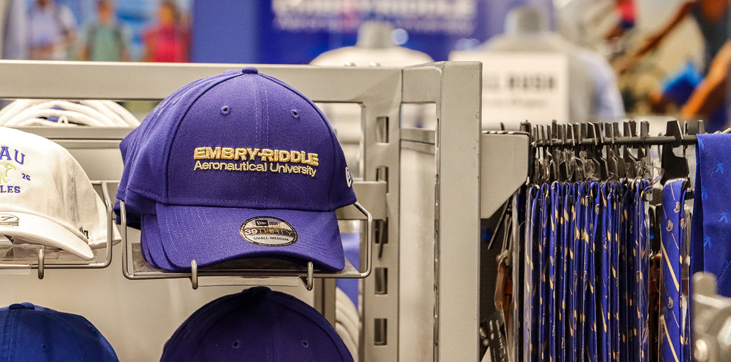 A rack of baseball hats in the Embry-Riddle bookstore
