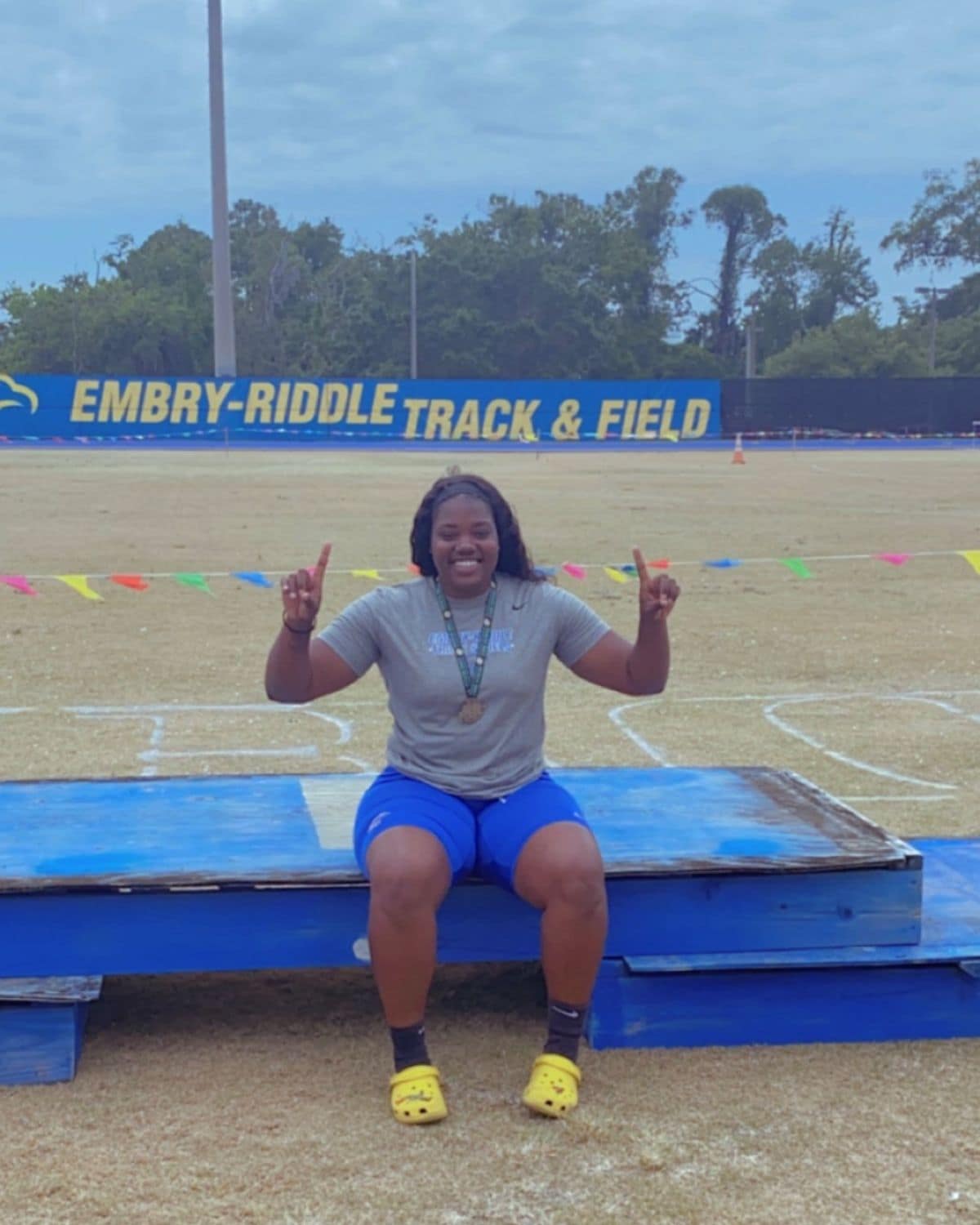 Ta'Leah Adams on Embry-Riddle’s Daytona Beach Campus, posing with the Track & Field sign. (Photo: Ta'Leah Adams)