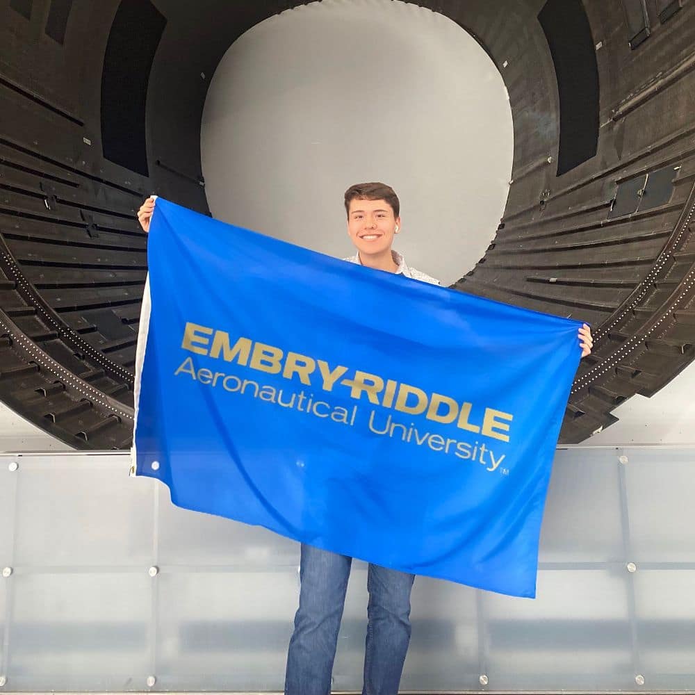 During at his summer internship at NASA, Connor Arnold took a minute to show off the Embry-Riddle flag as he stood in front of a rocket engine. (Photo: Connor Arnold)