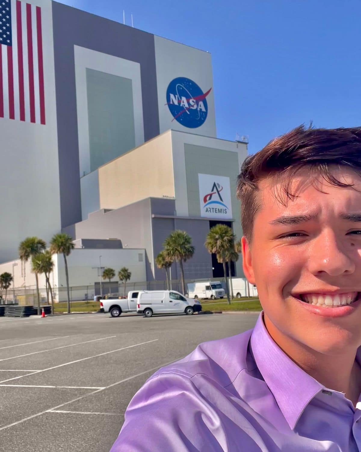 Aerospace Engineering student Connor Arnold with NASA’s Vehicle Assembly Building in the background. (Photo: Connor Arnold)