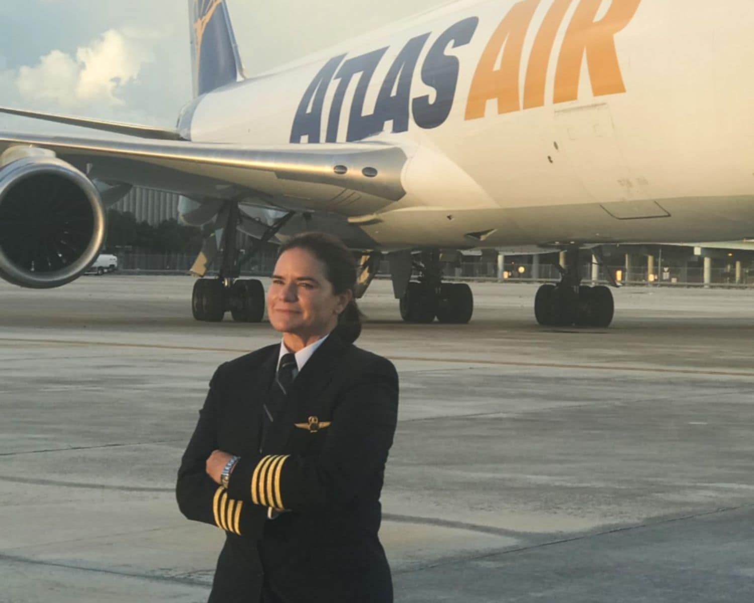 Embry-Riddle alumna and pilot for Atlas Air, Gina Buhl ('89) stands on the runway in front of a Boeing 747. (Photo: Gina Buhl)