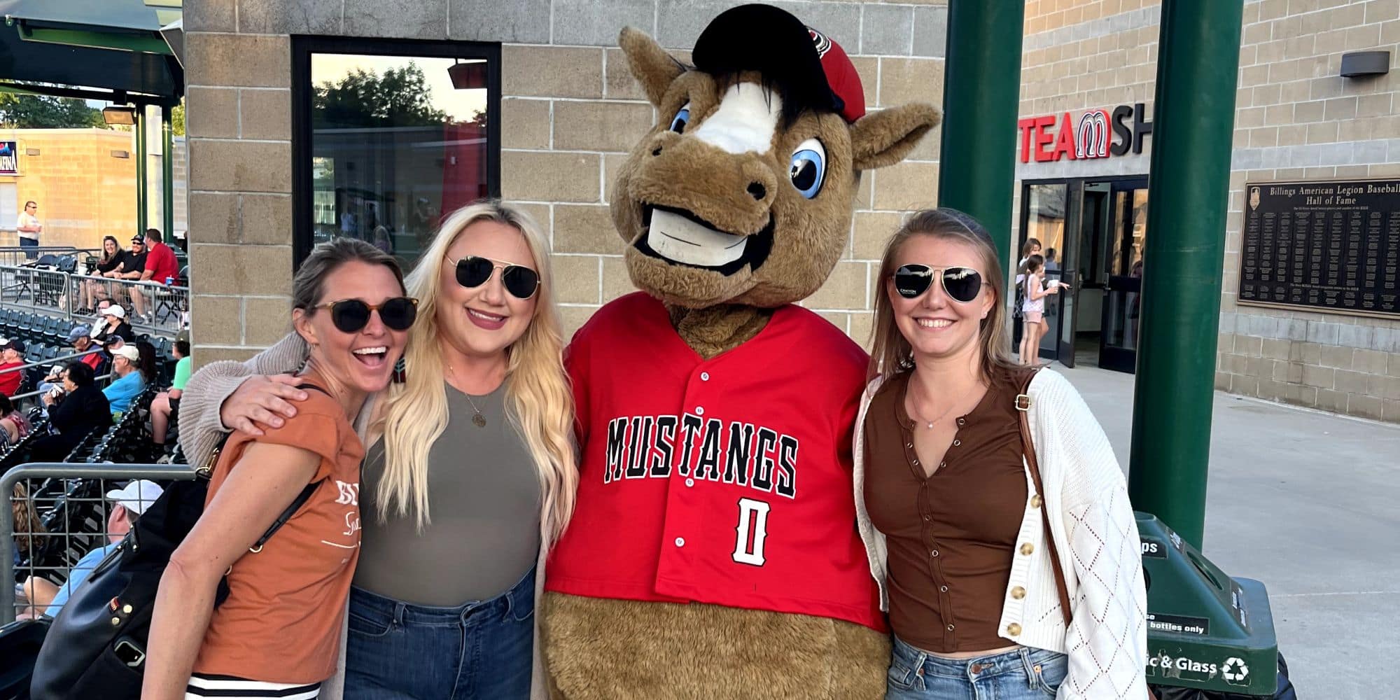 Megan Gill (right) and friends take time out to enjoy a minor league baseball game in Billings, Montana. (Photo: Megan Gill)