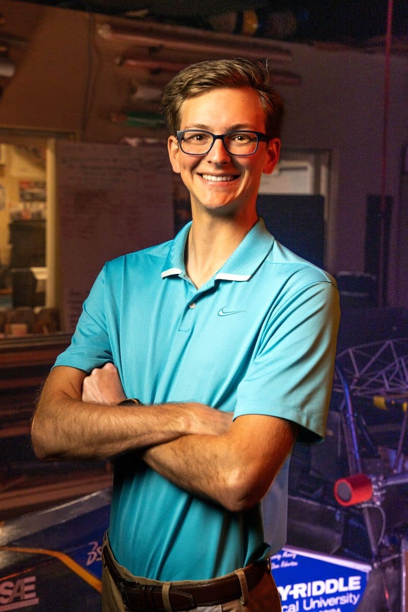 Mechanical Engineering student Matthew Jolliffe ('23) standing in Embry-Riddle's Formula One SAE Lab. (Photo: Embry-Riddle / Bill Fredette-Huffman)
