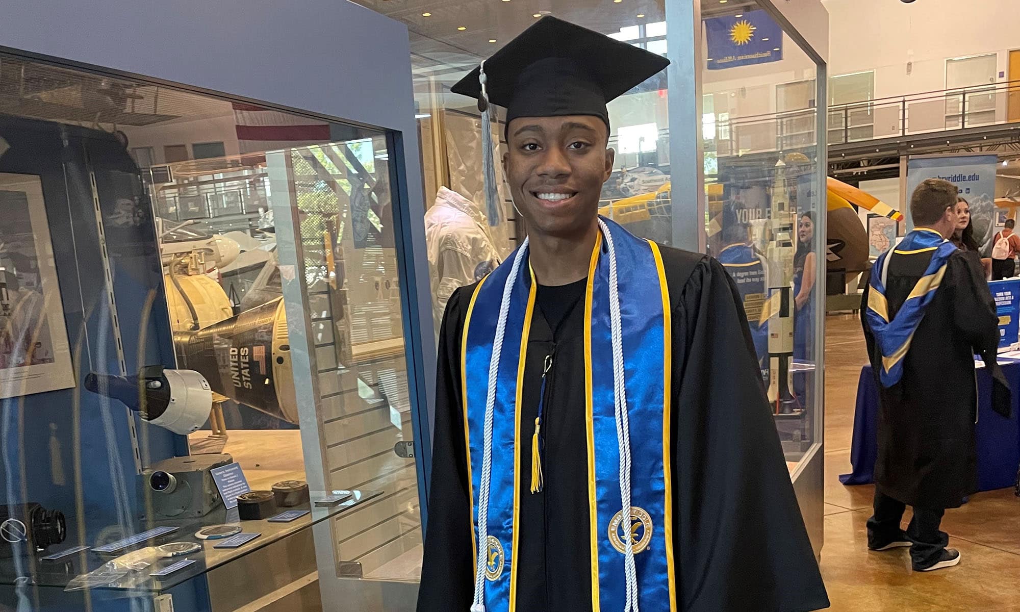 Kegan Martindale-Hernandez, shown here in cap and gown, celebrates earning his B.S. in Aeronautics during a Worldwide Campus graduation ceremony.