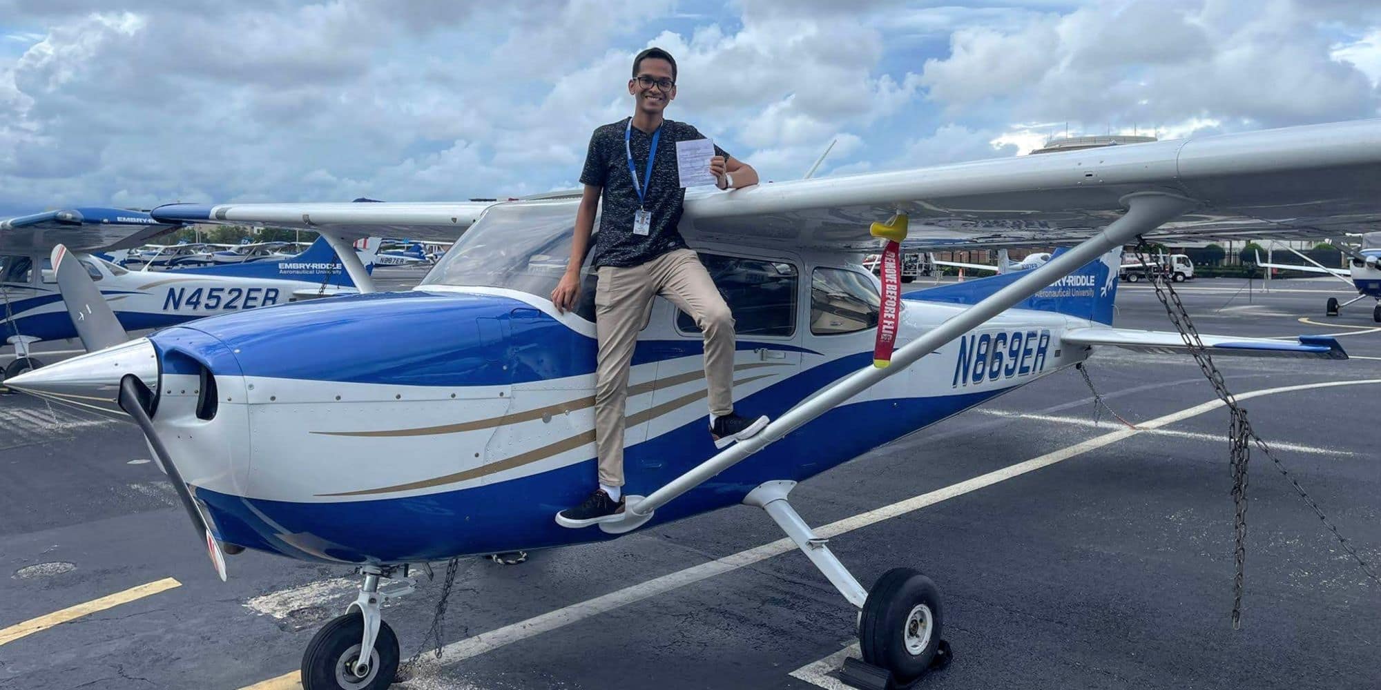 Standing on the strut of an Embry-Riddle Cessna 172, Dylan Kowlessar shows off his instrument rating. (Photo: Embry-Riddle / Daytona Beach Campus Flight Department)