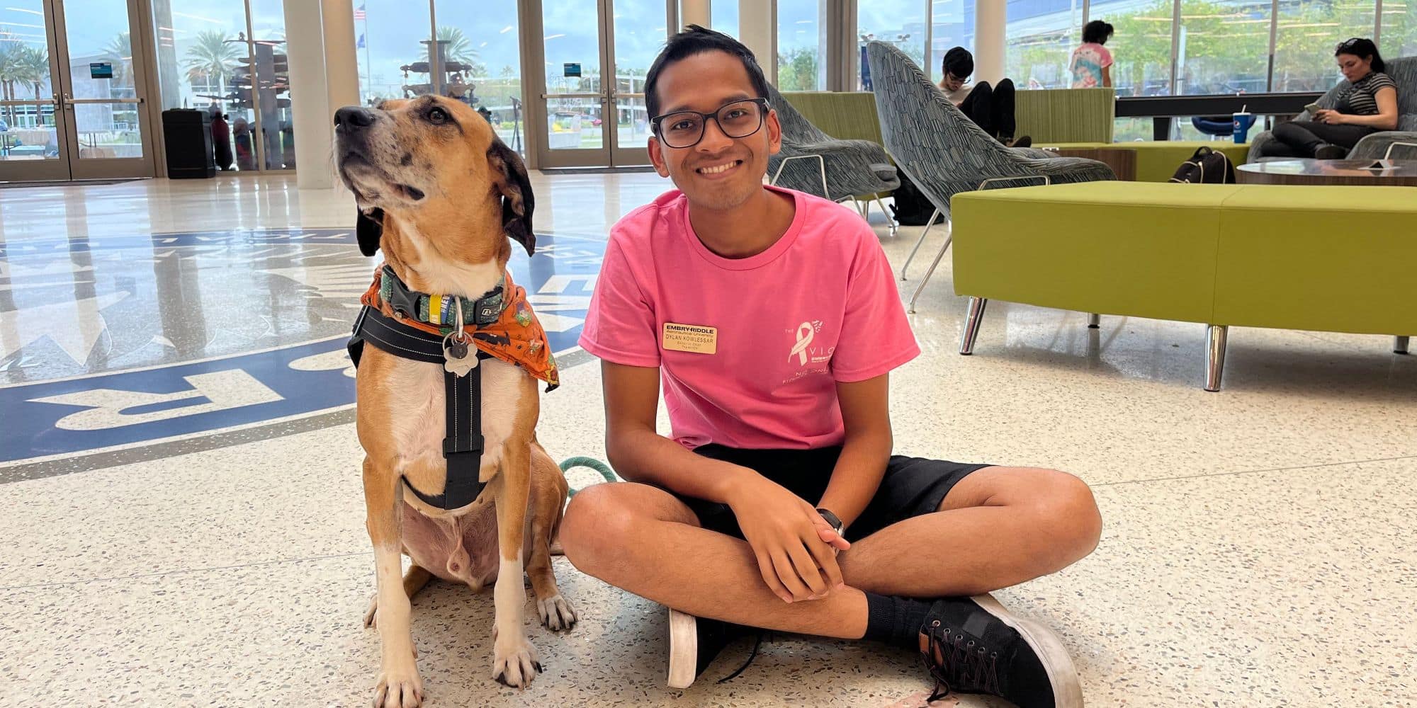 Dylan Kowlessar hangs out with his friend's dog Shadow in the Student Union in Fall 2022 (Photo: Dylan Kowlessar)