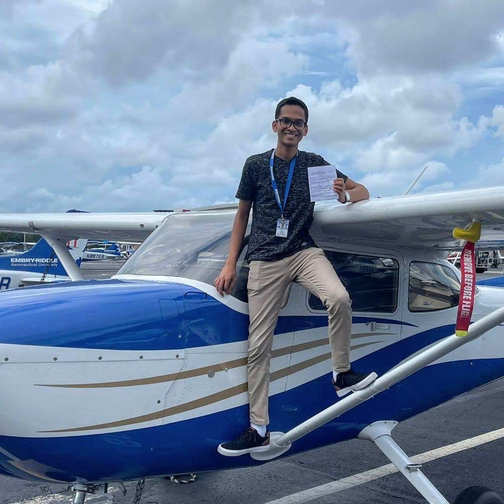 Standing on the strut of an Embry-Riddle Cessna 172, Dylan Kowlessar shows off his instrument rating. (Photo: Embry-Riddle / Daytona Beach Campus Flight Department)