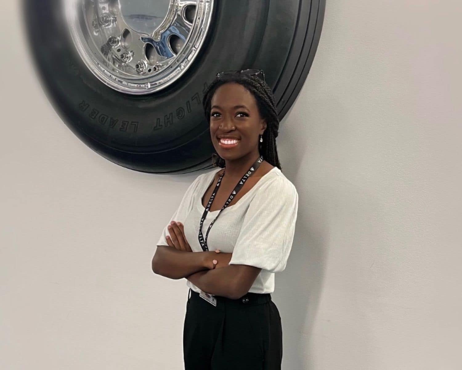 Faith Lee on her first day at Delta Air Lines, posing in front of an Airbus A320 tire. (Photo: Faith Lee / Delta Air Lines)