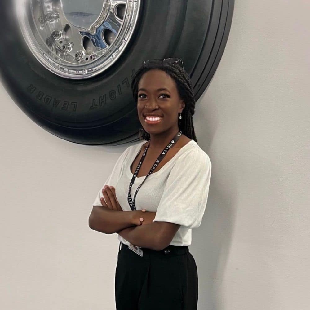 Faith Lee on her first day at Delta Air Lines, posing in front of an Airbus A320 tire. (Photo: Faith Lee / Delta Air Lines)