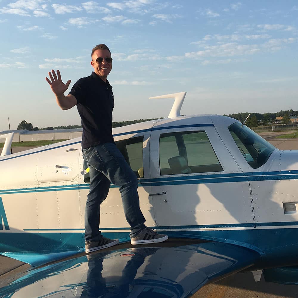 Embry-Riddle Aeronautical University student and veteran Matt Henkel atop his plane.