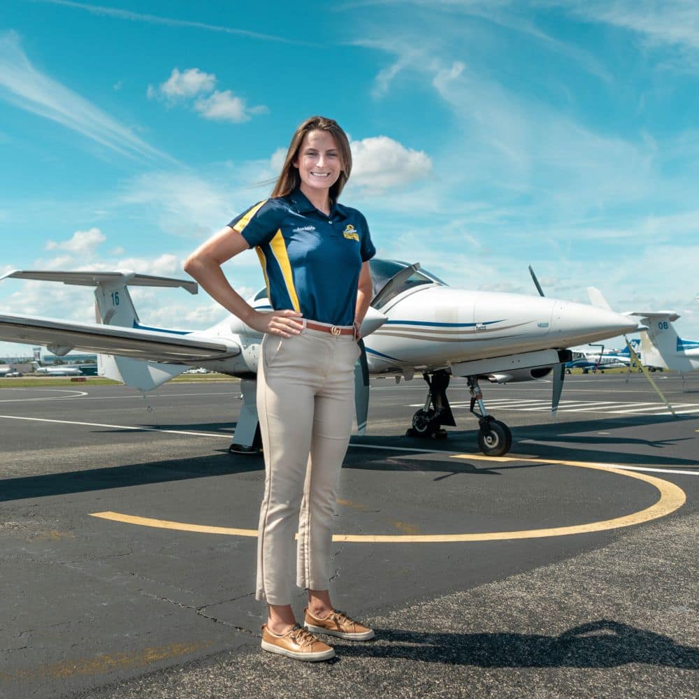Aeronautical Science student Ann Marie Petrone stands in front of our Diamond DA-42 Twin Star multi-engine aircraft. 