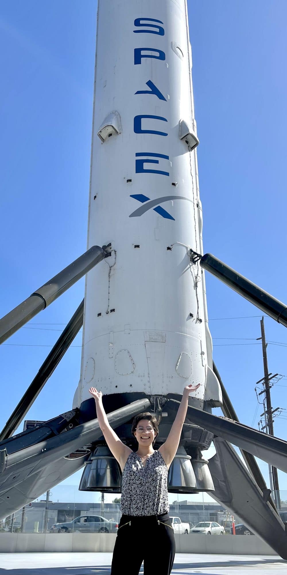 Poteet in front of the Falcon 9 booster after completing an inspection at SpaceX Headquarters. (Photo: JaciLynn Poteet)