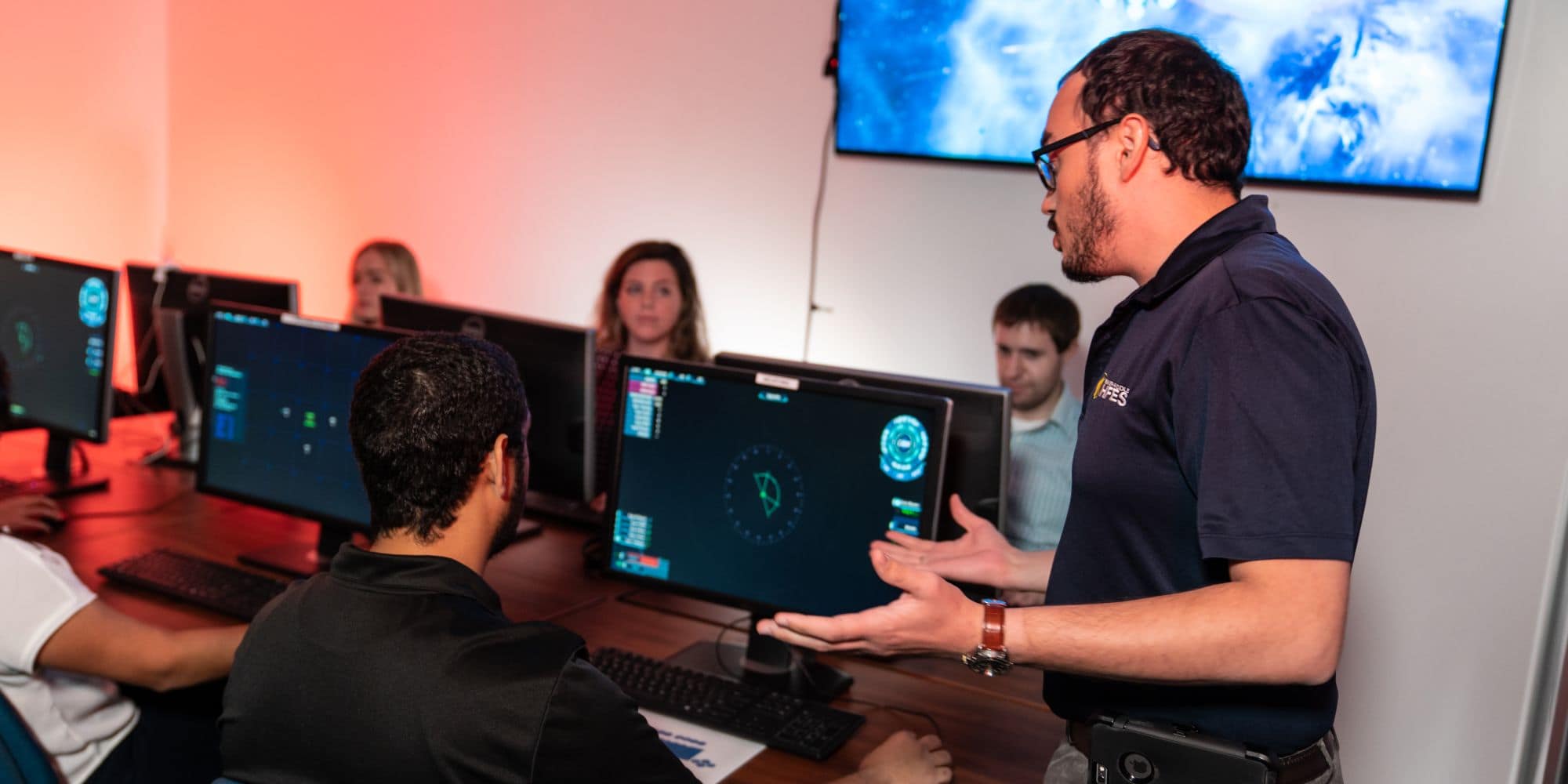 ERAU students in the Human Factors GEARS Lab play the "Artemis Spaceship Bridge Simulator" game used to study the dynamics of teamwork. Pictured: Jessyca Derby, Jacqueline Mcsorley, William Shelstad, Ameer Hosein, and Richard John Simonson (Embry-Riddle / Daryl LaBello)