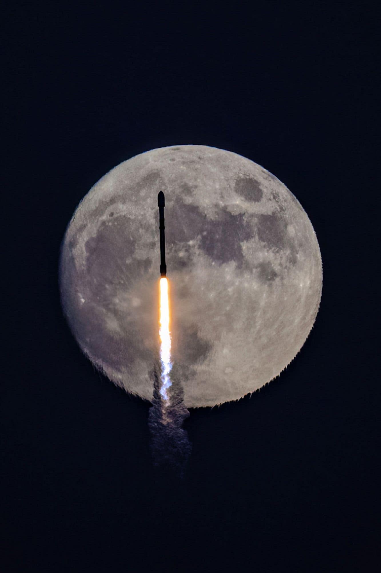 A night launch of a rocket as it passes in front of a full moon. (Photo: Wen Wu)
