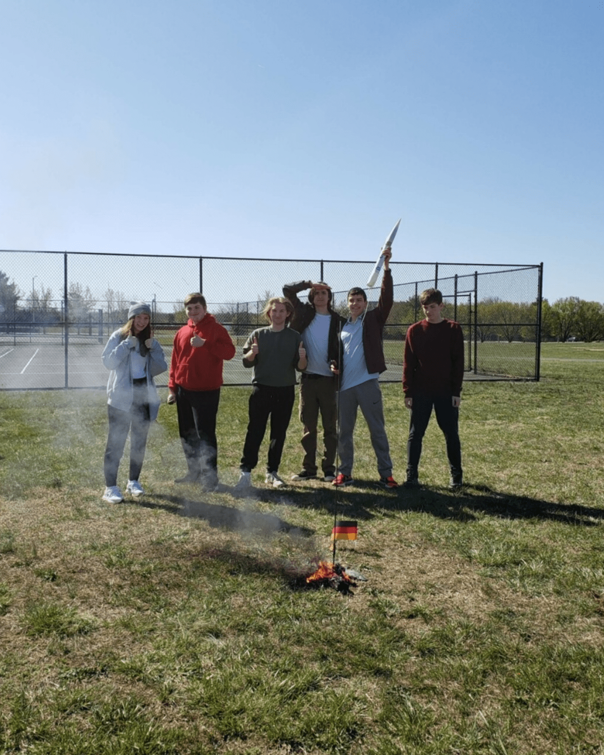 Not every launch goes as planned. Jacob Zahabi (second from right) holds the top end of a rocket that blew up on ignition and left a small fire. (Photo: Jacob Zahabi)