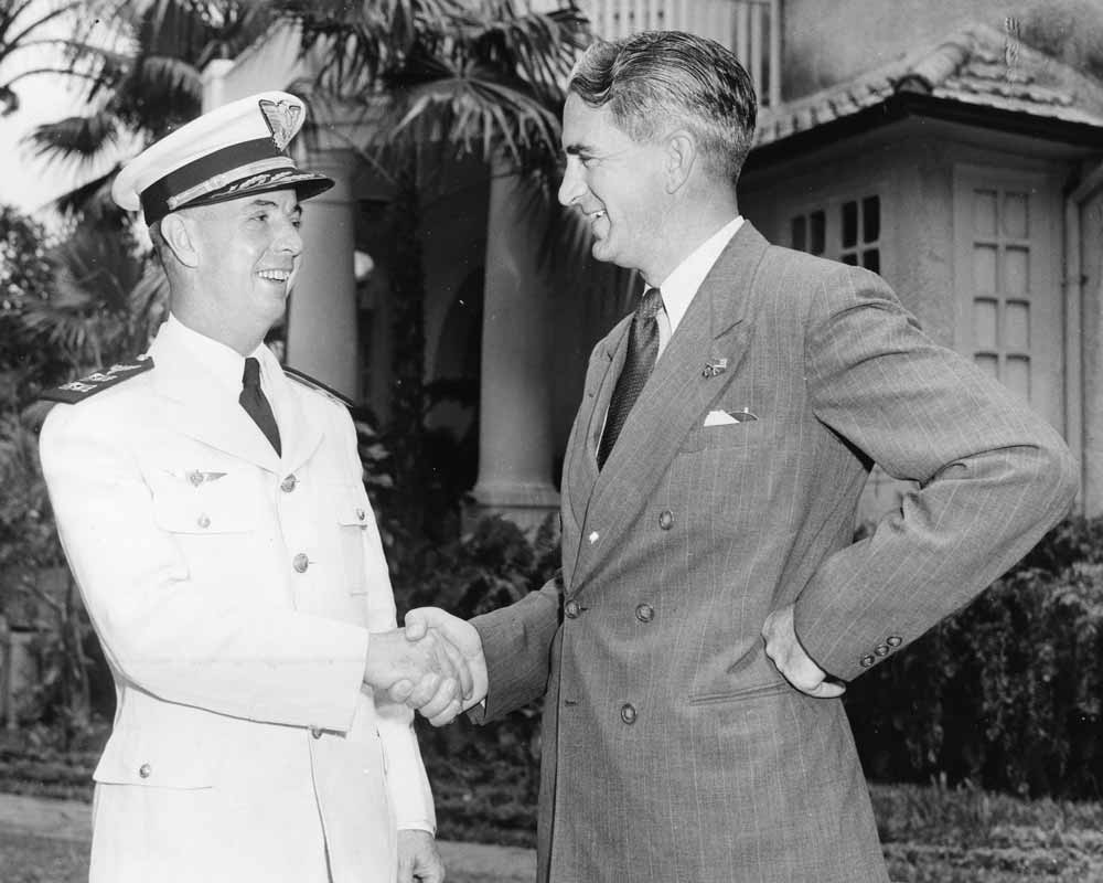 Brigadier General Appel Netto, Commanding Officer of the 4th Air Zone, shakes hands with Mr. John Paul Riddle, President of Embry-Riddle Company in Rio de Janeiro, Brazil.