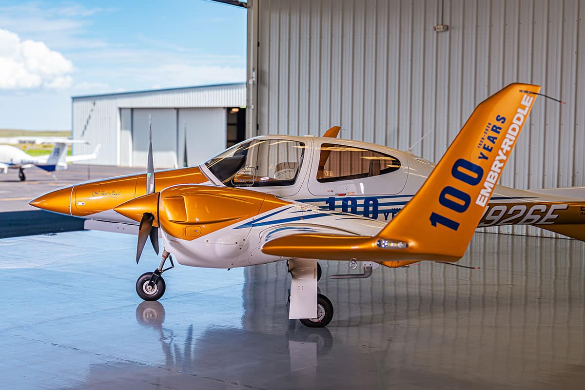 An aircraft parked in a hangar features designs celebrating Embry-Riddle's 100th Anniversary.