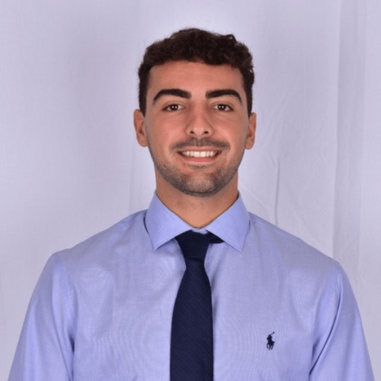 David Velasco, dressed professionally in front of a blank wall.