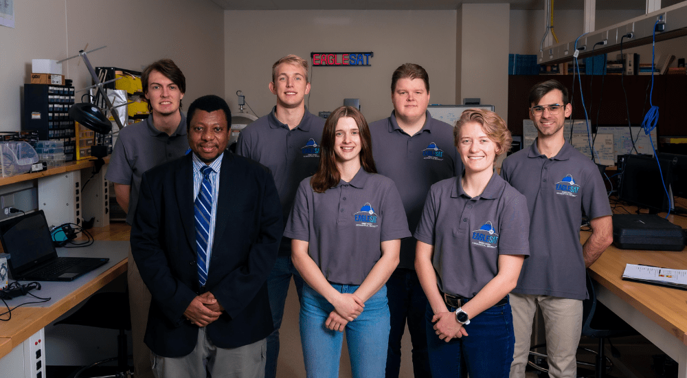 Members of the capstone team, alongside project sponsor Dr. Sulyman, pose for a celebratory photo after their hard work laying the foundation for the ground station and communication infrastructure throughout spring semester, 2022. Left to right, front to back: Dr. Sulyman, Cardeen Mckelvey, Parker Landon, Brett Stricker, Joshua Parmenter, Matthew Gary and Stephen Mouhanna.