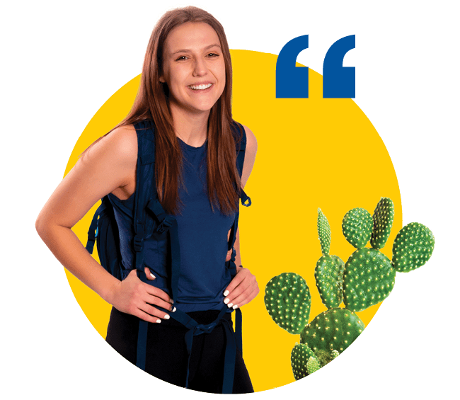 Emma, with long hair, wears a backpack. Next to her is a cactus.