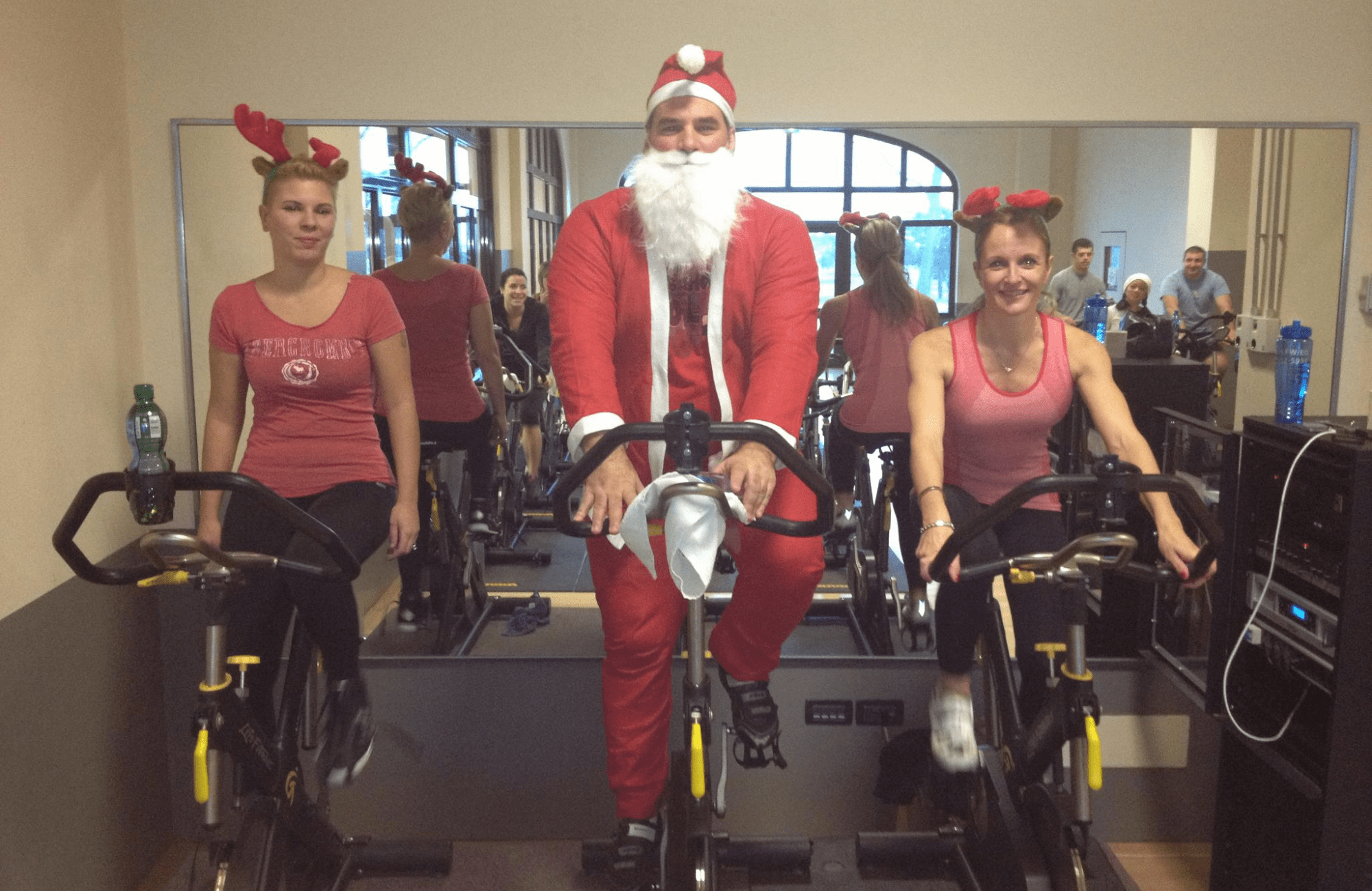 3.	Mark serving as a spin instructor at Aviano Air Base Italy during a 2011 Christmas special Spin Class in collaboration with other instructors.