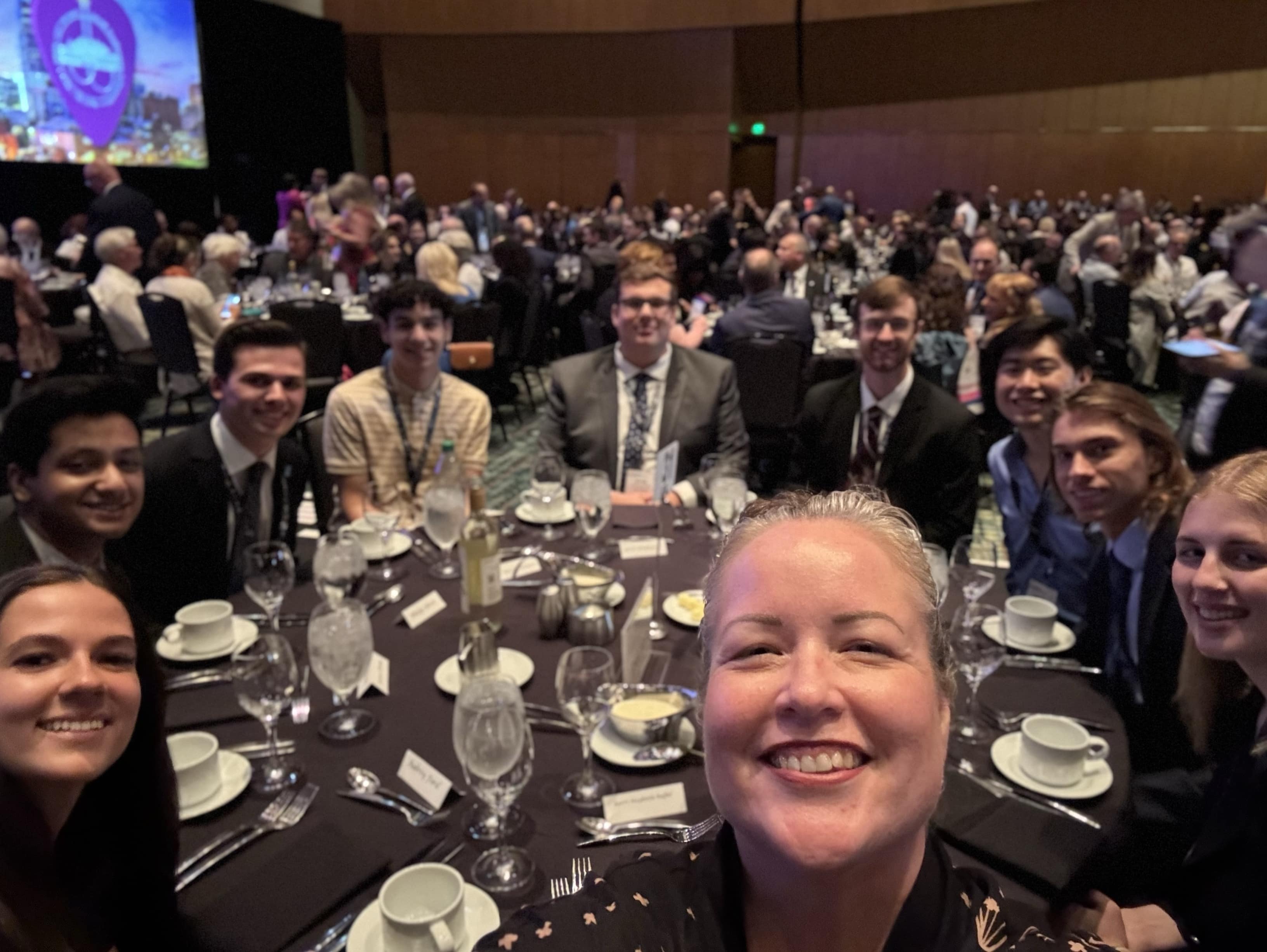 Kerri Haybittle-Raffel at the final dinner of the National Conference with Embry-Riddle students Jeswin Thomas (second from left) and Adam Zaraszczak (second from right).