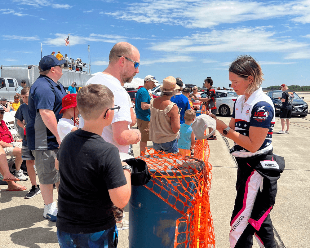 Melissa Burns signing autographs at an airshow.