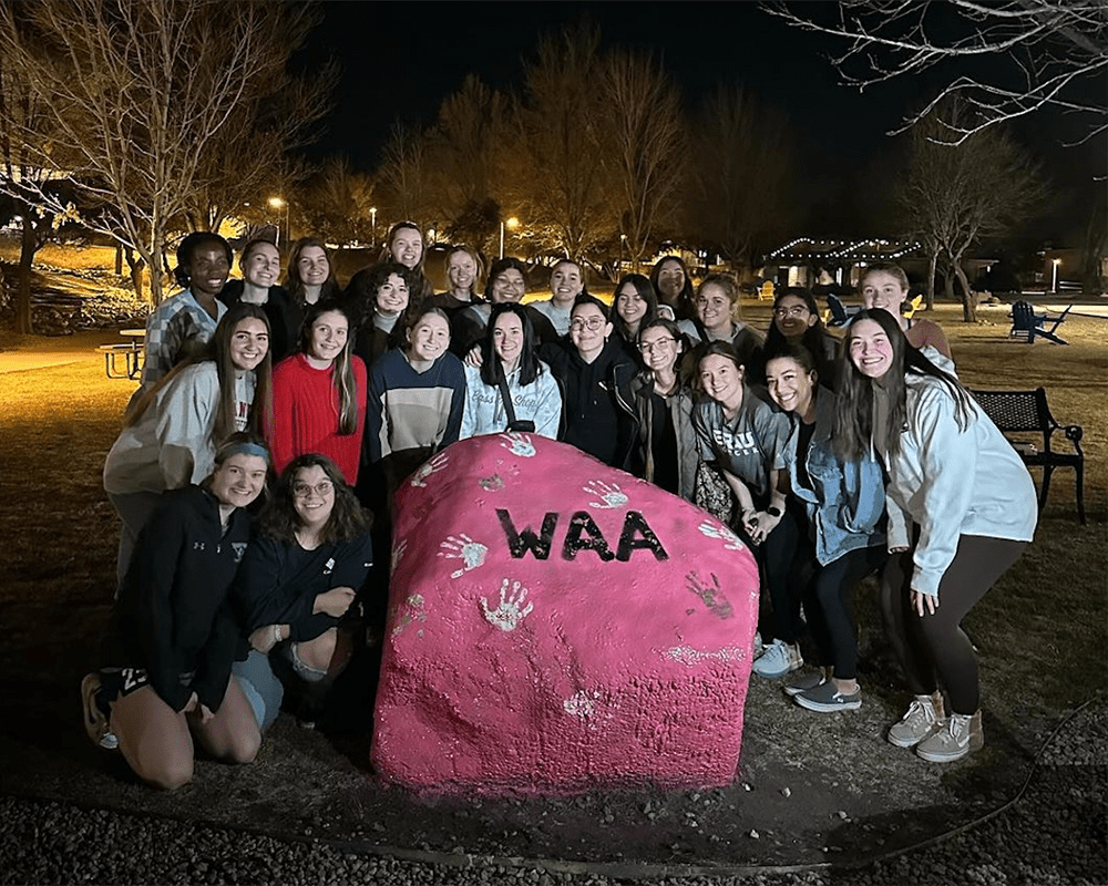 Makenzi Patterson and members of the WAA gather on Embry‑Riddle's Prescott Campus after painting the Spirit Rock. (Photo: Makenzi Patterson) 