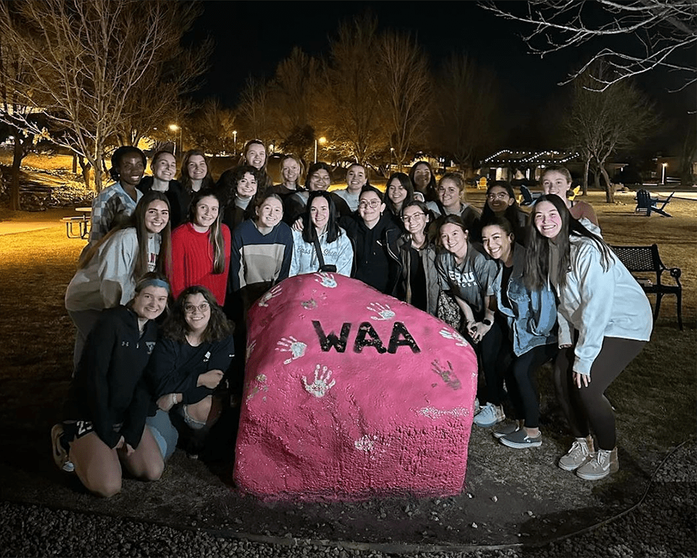 Makenzi Patterson and members of the WAA gather on Embry‑Riddle's Prescott Campus after painting the Spirit Rock. (Photo: Makenzi Patterson)