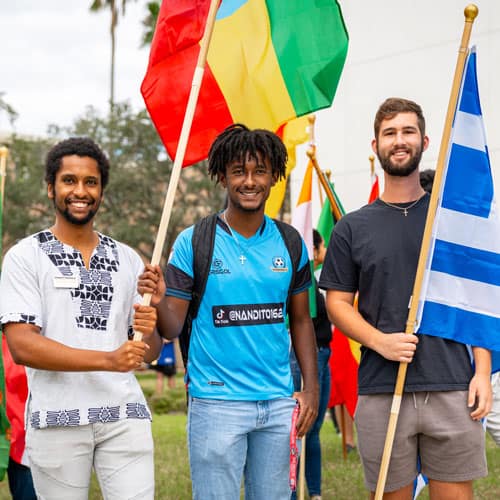 Three students holding flags